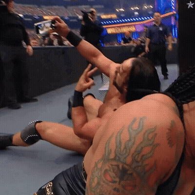 A Wrestler With A Tattoo On His Arm Takes A Picture GIF