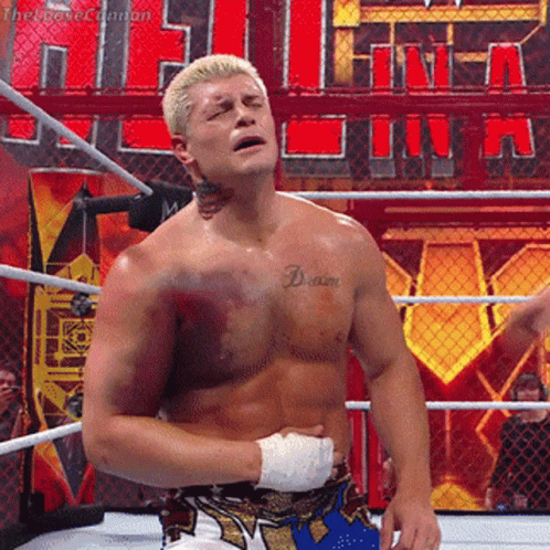 A Wrestler With A Tattoo On His Chest That Says " Dream " GIF