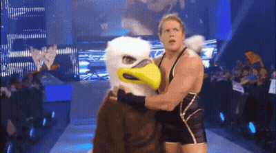 A Wrestler With An Eagle Mask Is Wrestling A Mascot GIF