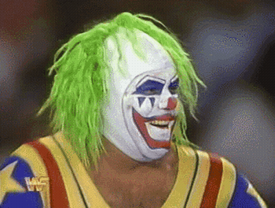 A Wrestler With Green Hair And A Clown Mask GIF