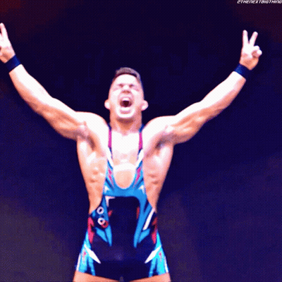 A Wrestler With His Arms Outstretched With The Next Thing Written On The Bottom Right GIF