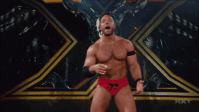 A Wrestler With The Number 37 On His Shorts Stands On A Stage GIF