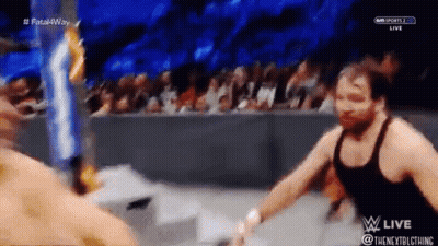 A Wrestling Match Is Being Broadcast Live On A Television Screen . GIF