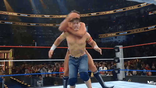 A Wrestling Match Is Being Shown On A Screen That Says Minute Maid GIF