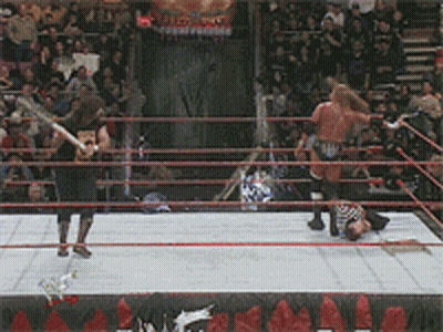 A Wrestling Match Is Going On In A Ring With A Sign That Says ' Wrestling ' On It GIF