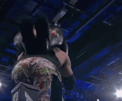A Wrestling Match Is Going On In Front Of A Crowd With A Sign That Says " I Love You " On It GIF