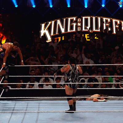 A Wrestling Match Is Taking Place In Front Of A Sign That Says King Of Kings GIF