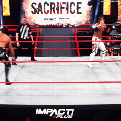 A Wrestling Ring With The Word Sacrifice On The Wall GIF