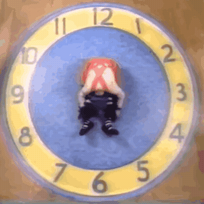 A Yellow And Blue Clock With A Person 'S Head In The Middle GIF