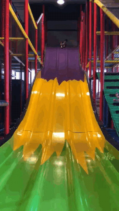 A Yellow And Green Slide With A Purple Top GIF
