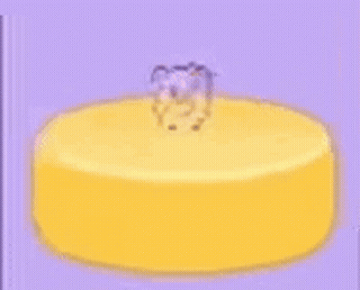 A Yellow Cake With A Teddy Bear On Top Of It . GIF