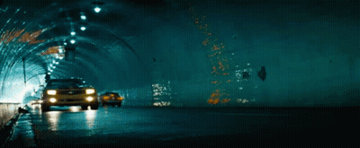 A Yellow Car Is Driving Through A Tunnel GIF