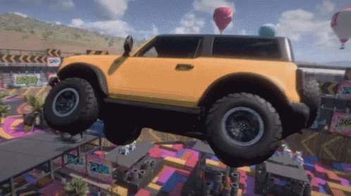 A Yellow Car Is Flying Through The Air With A Sign That Says Xtreme GIF