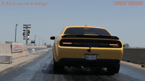 A Yellow Car With A License Plate That Says Knz-2157 GIF
