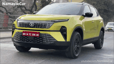 A Yellow Car With A License Plate That Says Mh14tc206ak GIF