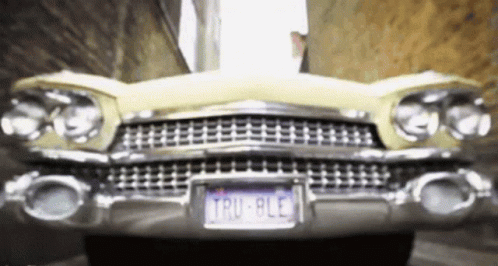 A Yellow Car With A License Plate That Says Tru 8Le GIF
