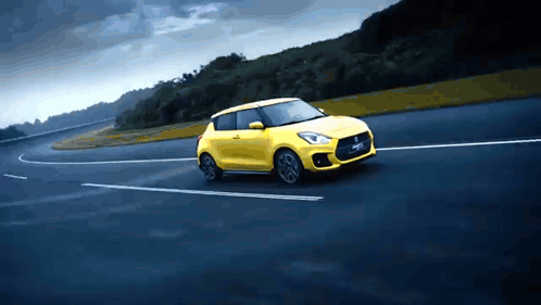 A Yellow Car With The Word Swift On The Side GIF