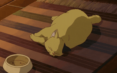 A Yellow Cat Is Laying On A Striped Rug Next To A Bowl Of Food GIF