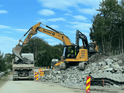 A Yellow Excavator With The Word Rustad On The Side GIF