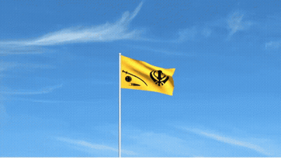 A Yellow Flag With A Khanda On It Is Flying In The Wind GIF
