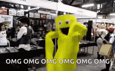 A Yellow Mascot Is Dancing In A Room With People Standing Around . GIF