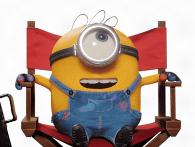 A Yellow Minion Is Sitting In A Red Directors Chair GIF