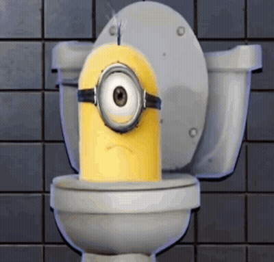 A Yellow Minion Is Sitting On A Toilet With A Sad Look On His Face GIF