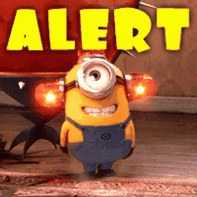 A Yellow Minion Is Standing In Front Of A Sign That Says " Alert " GIF