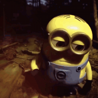 A Yellow Minion With Big Eyes And A Blue Belt Around His Neck GIF