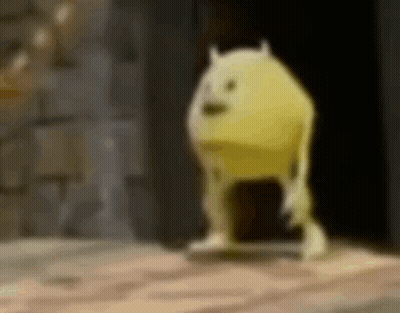 A Yellow Monster From Monsters Inc Is Standing On A Wooden Floor In A Dark Room . GIF