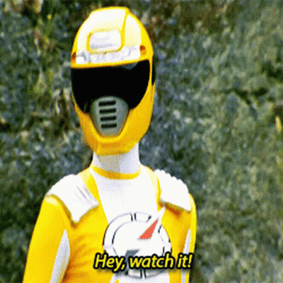 A Yellow Ranger Says " Hey Watch It " While Wearing A Helmet GIF