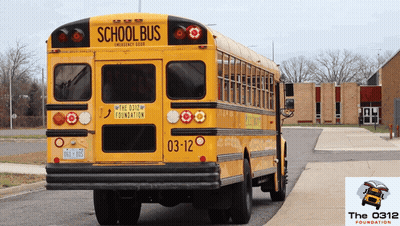 A Yellow School Bus With The 0312 Foundation Written On The Back GIF