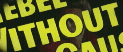 A Yellow Sign That Says Rebel Without Cause On It GIF