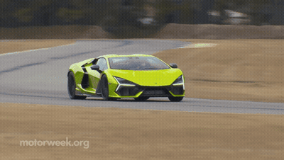 A Yellow Sports Car Is Driving Down A Road With Motorweek.org Written On The Bottom Right GIF