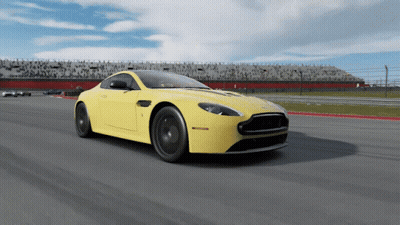 A Yellow Sports Car Is Driving Down A Track GIF