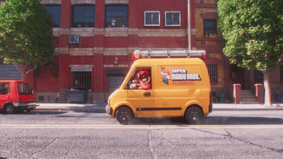 A Yellow Super Mario Bros Plumbing Van Drives Down A City Street GIF