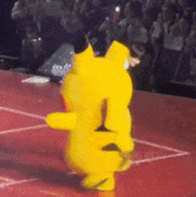 A Yellow Teddy Bear Is Dancing On A Red Floor GIF