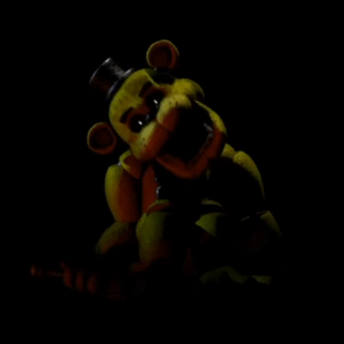 A Yellow Teddy Bear With A Top Hat Is In The Dark . GIF