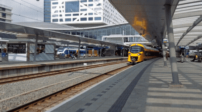 A Yellow Train At A Station With A Sign That Says ' Nsb ' On It GIF