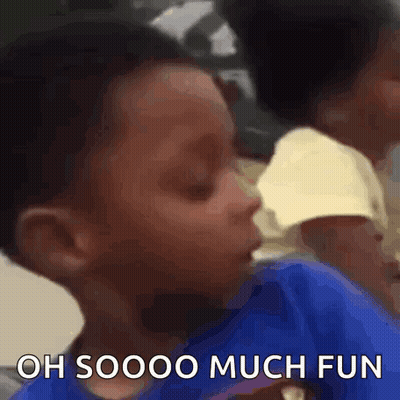 A Young Boy In A Blue Shirt Is Making A Funny Face And Saying `` Oh Soooo Much Fun '' . GIF