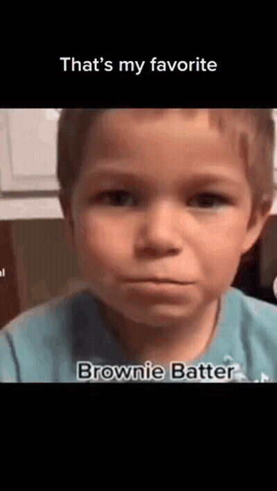 A Young Boy In A Blue Shirt Is Making A Funny Face And Saying `` That 'S My Favorite Brownie Batter '' . GIF