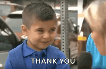 A Young Boy In A Blue Shirt Is Talking To A Woman In A Parking Lot . GIF