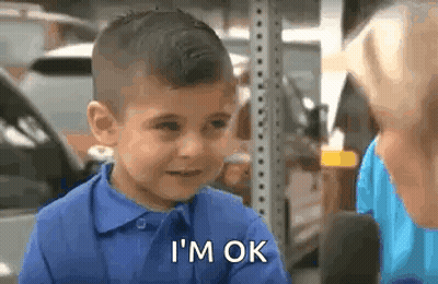 A Young Boy In A Blue Shirt Is Talking To A Woman In A Parking Lot . GIF