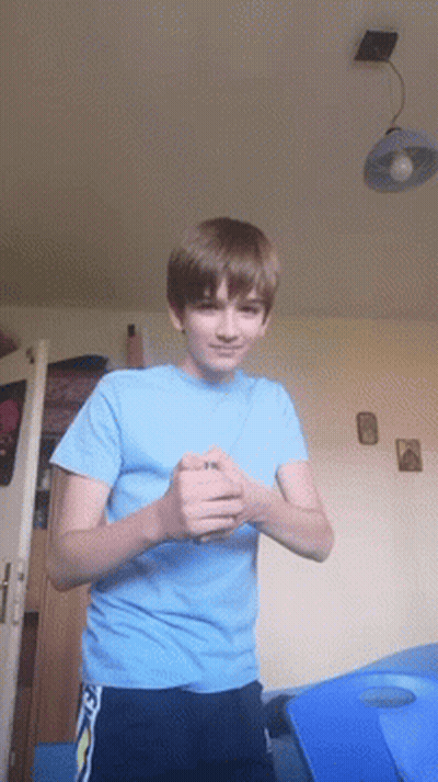 A Young Boy In A Blue Shirt With The Letter N On It GIF