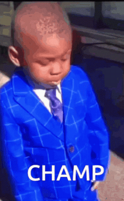 A Young Boy In A Blue Suit And Tie With The Word Champ On The Bottom GIF