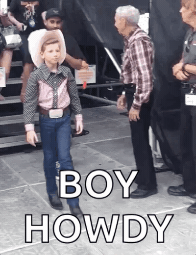 A Young Boy In A Cowboy Outfit Is Standing Next To A Man In A Plaid Shirt And Says Boy Howdy GIF