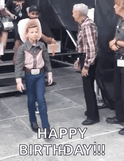 A Young Boy In A Cowboy Outfit Is Walking On A Stage And Says `` Happy Birthday ! '' GIF
