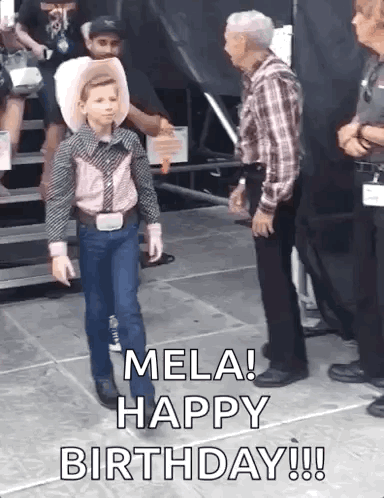A Young Boy In A Cowboy Outfit Is Walking On A Stage While A Man Stands Behind Him And Says Mela Happy Birthday GIF