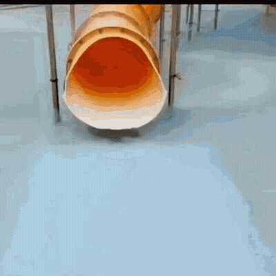 A Young Boy In A Green Shirt Is Playing In A Pool GIF