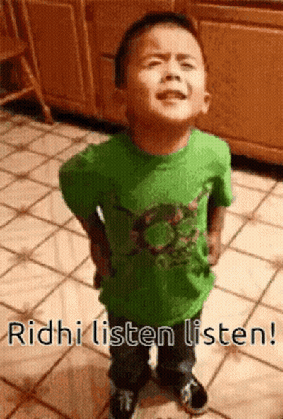 A Young Boy In A Green Shirt Is Standing On A Tiled Floor With The Words Ridhi Listen Listen . GIF